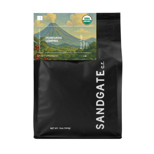 Black coffee bag with 'Sandgate' branding and a scenic label on a white background